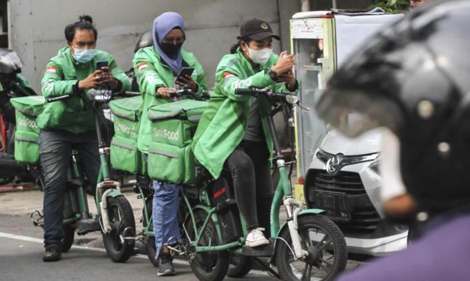Grab, Gojek parent eye merger this year